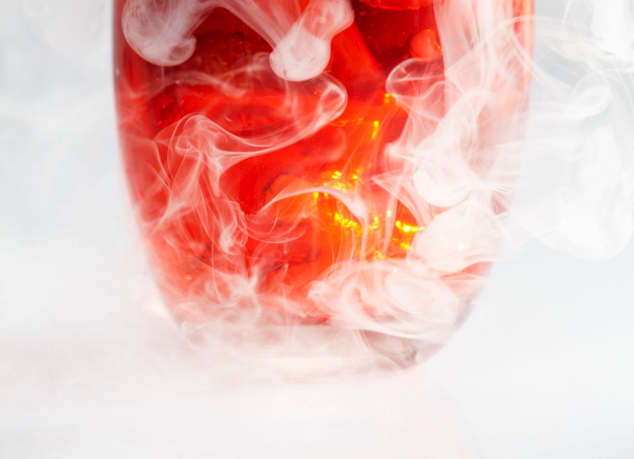 Strawberry punch in glass with dry ice mist